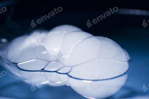 Preview: Abstract Shot With Big Soap Bubbles On A Water Surface With Smoke Inside. Image Has Grain Texture