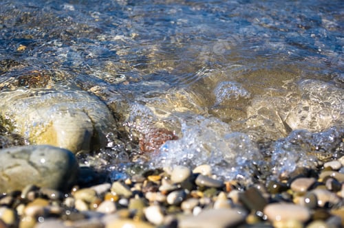 Preview: Sea Pebble Beach With Multicoloured Stones, Transparent Waves With Foam, On A Warm Summer Day