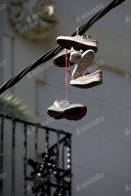 Preview: Old Sneakers Hanging From A Cable.