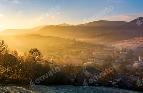 Preview: Spectacular Foggy Sunrise In Mountainous Countryside. Gorgeous Autumnal Landscape With Village In