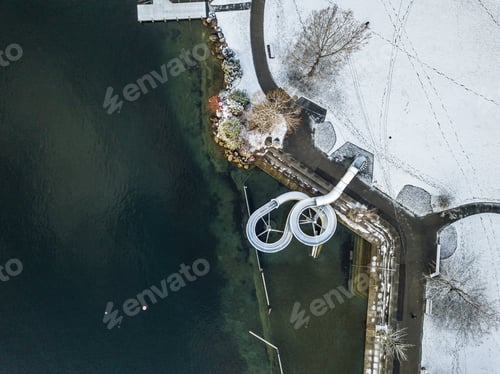 Preview: Aerial View Of Water Slide On Lake Shore In Winter Time. Snow Covered Surface Of Leisure Park In
