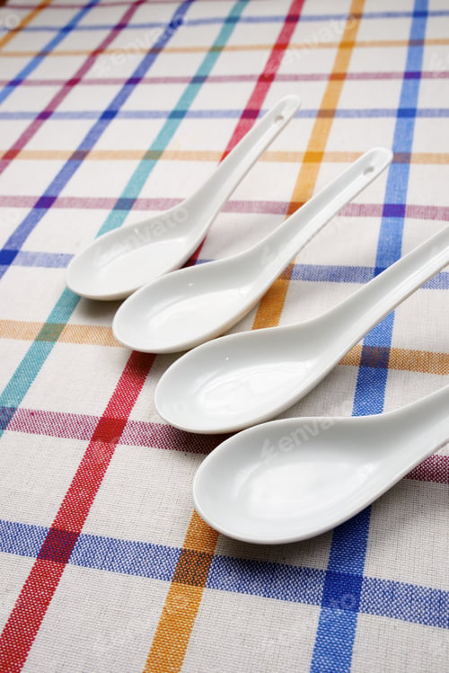 Preview: Small White Spoons On A White Tablecloth