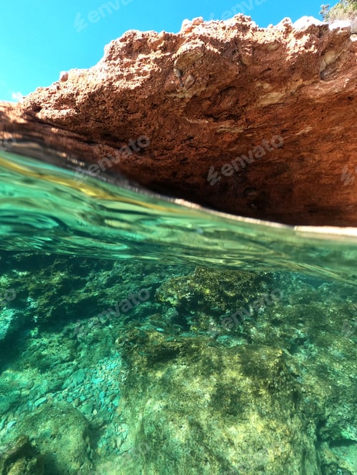 Preview: Split Underwater Photo Of Exotic Island Cave With Rocky Emerald Seascape