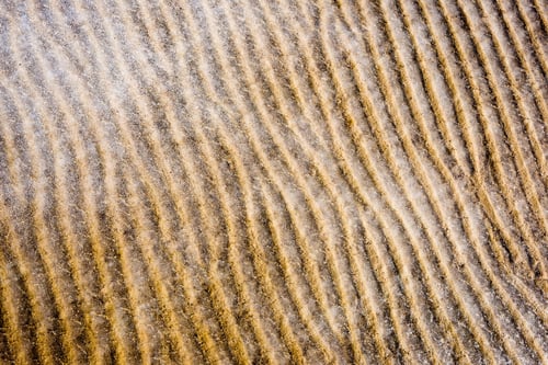 Preview: Frozen Sand With Ice Blocks. Abstract Texture In Natural Beach