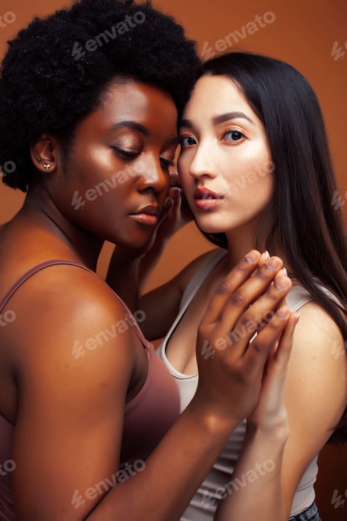 Preview: Young Pretty Asian And Afro Woman Posing Cheerful Together On Brown Background, Lifestyle Diverse
