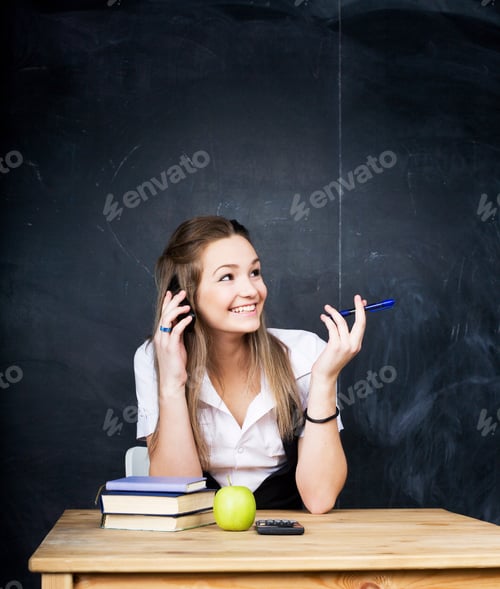 Preview: Young Pretty Girl Student In Classroom At Blackboard Doing Homework Smiling
