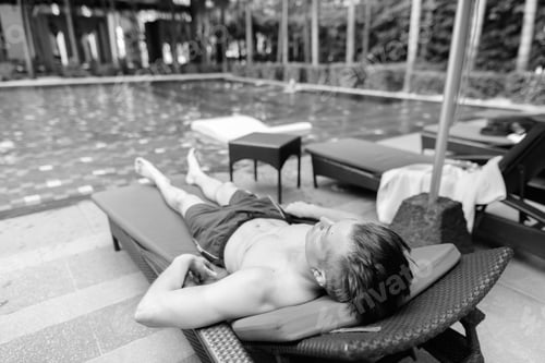 Preview: Young Handsome Man Relaxing By Swimming Pool In Hotel