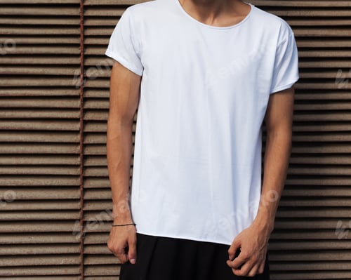 Preview: Fashion Of The Young. A Man In A White T-Shirt Posing On A Rusty Metal Background In The Summer