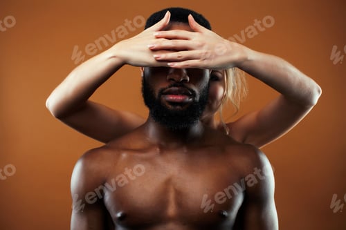 Preview: Young Pretty Couple Diverse Races Together Posing Sensitive On Brown Background, Lifestyle People