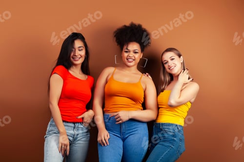 Preview: Young Pretty Multiracial Girls Posing Cheerful On Brown Background, Lifestyle People Concept