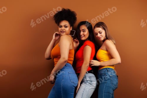 Preview: Young Pretty Asian, Caucasian, Afro Woman Posing Cheerful Together On Brown Background, Lifestyle