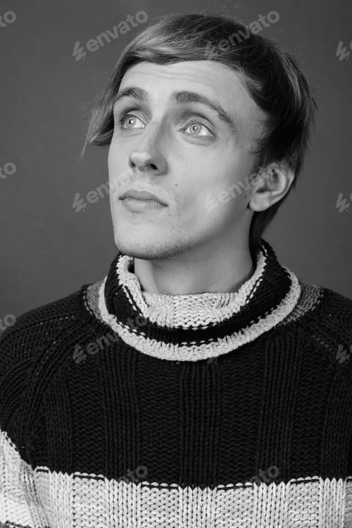 Preview: Young Handsome Man With Blond Hair Against Gray Background