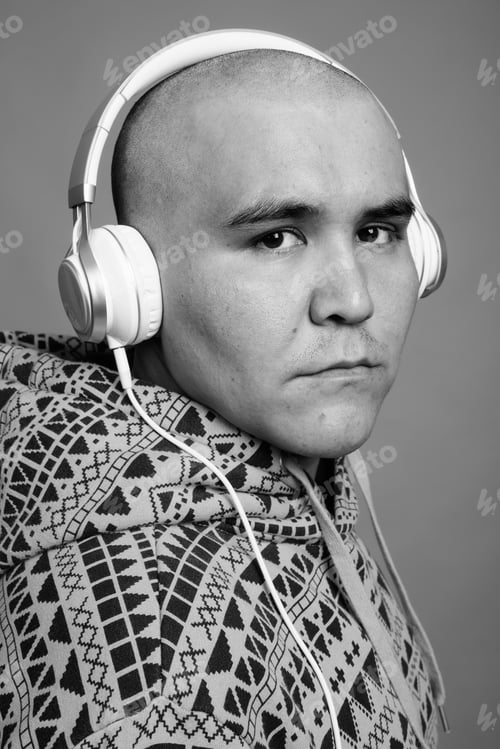 Preview: Portrait Of Young Bald Asian Man Listening To Music