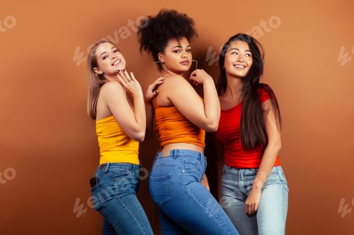 Preview: Young Pretty Multiracial Girls Posing Cheerful On Brown Background, Lifestyle People Concept