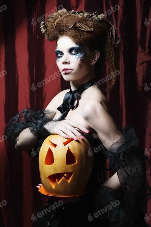 Preview: Halloween Witch With Carved Pumpkin Over Red Background.