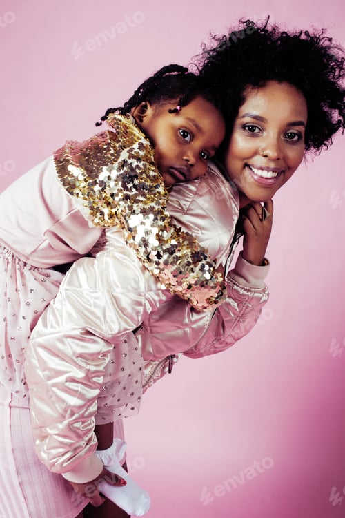Preview: Young Pretty African-American Mother With Little Cute Daughter Hugging, Happy Smiling On Pink