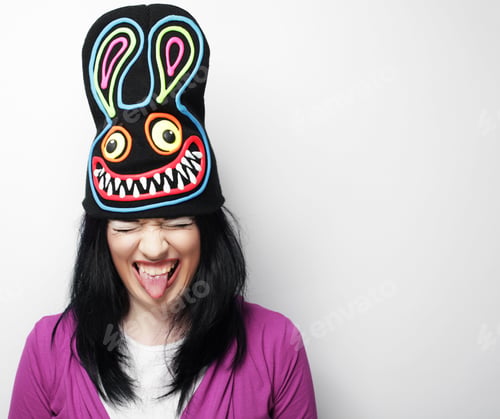 Preview: Playful Young Woman In Funny Hat With Rabbit, Studio Shot