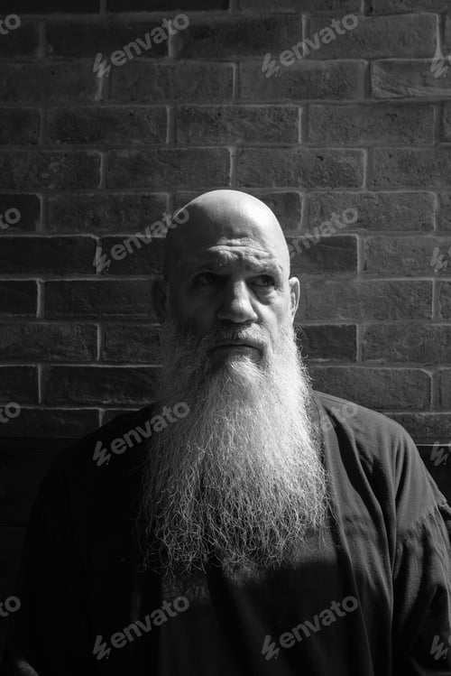 Preview: Black And White Portrait Of Mature Man With Long Gray Beard Thinking