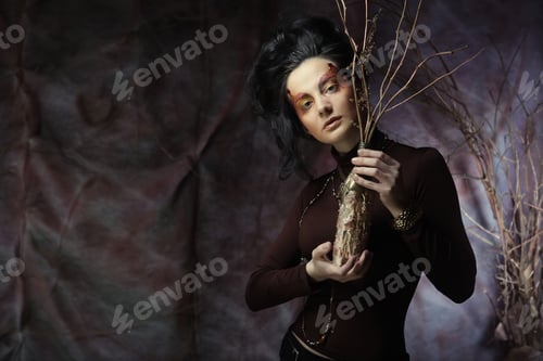 Preview: Young Woman With Bright Make Up With Dry Branches