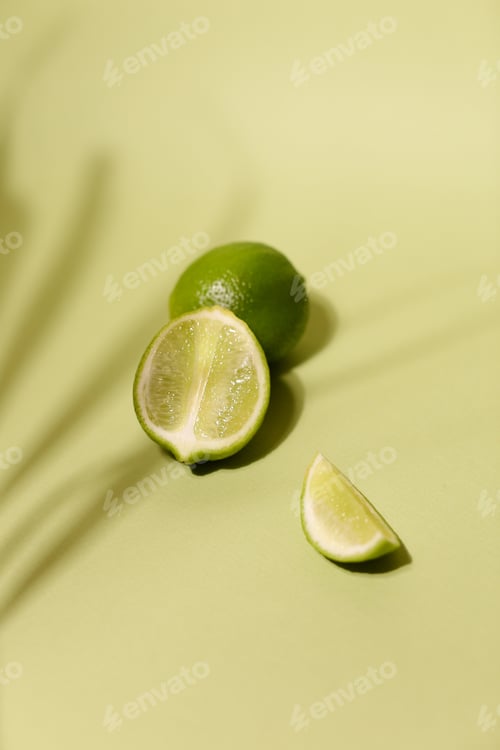 Preview: Fresh Lime And Slice, Isolated On Light Green Background