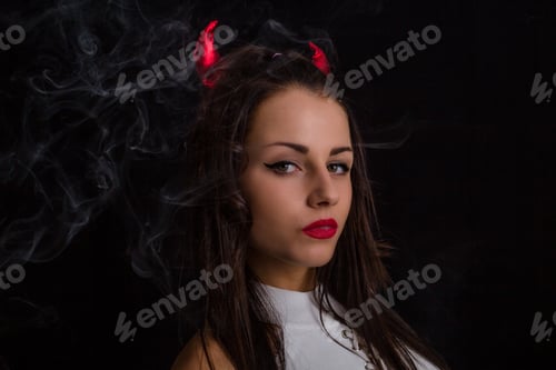 Preview: Woman With Devil Horns And Cigarette Smoke Posing On Black Background