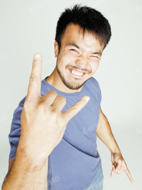Preview: Young Cute Asian Man On White Background Gesturing Emotional, Pointing, Smiling, Lifestyle People