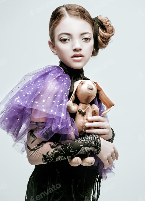Preview: Beautiful Girl Child Model In Fashionable Clothes Holding A Rabbit Toy, Close Up