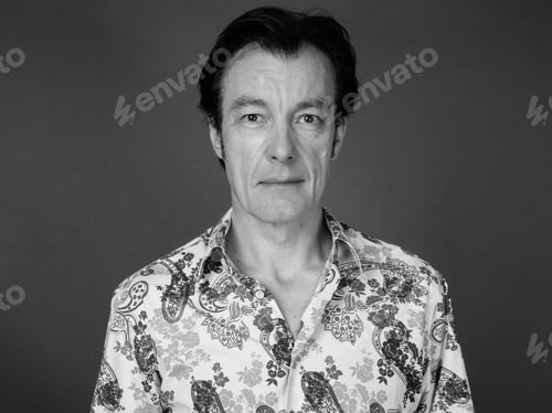 Preview: Mature Handsome Tourist Man Against Gray Background