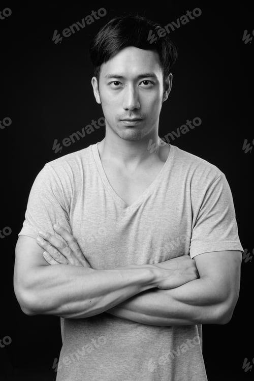 Preview: Young Handsome Asian Man Against Black Background