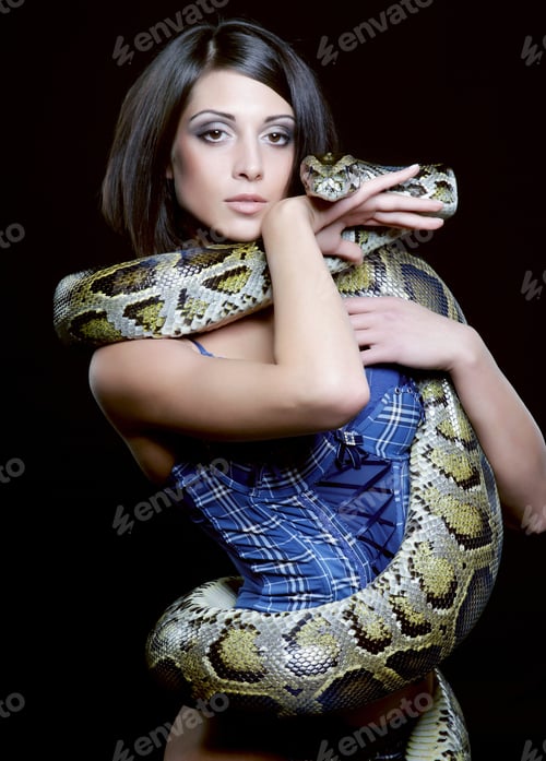 Preview: Sexy Brunette Holding Python Over Black Background