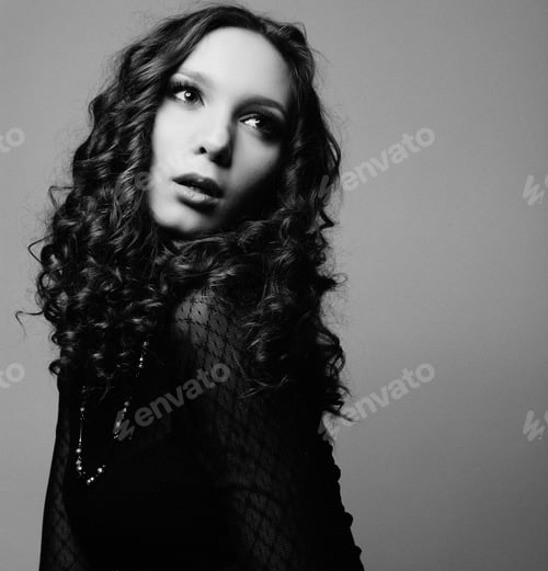 Preview: Portrait Of Beautiful Fashion Model Posing Over Gray Background. Black And White Studio Shot