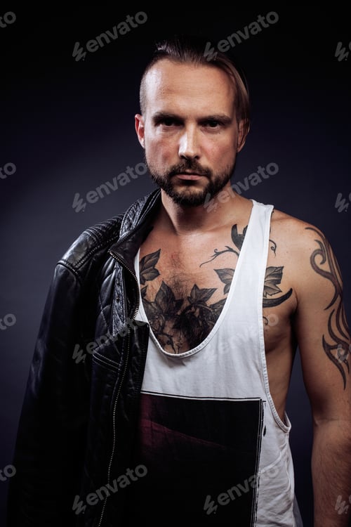 Preview: A Man With Tattooes On His Arms. Silhouette Of Muscular Body. Caucasian Brutal Hipster Guy With