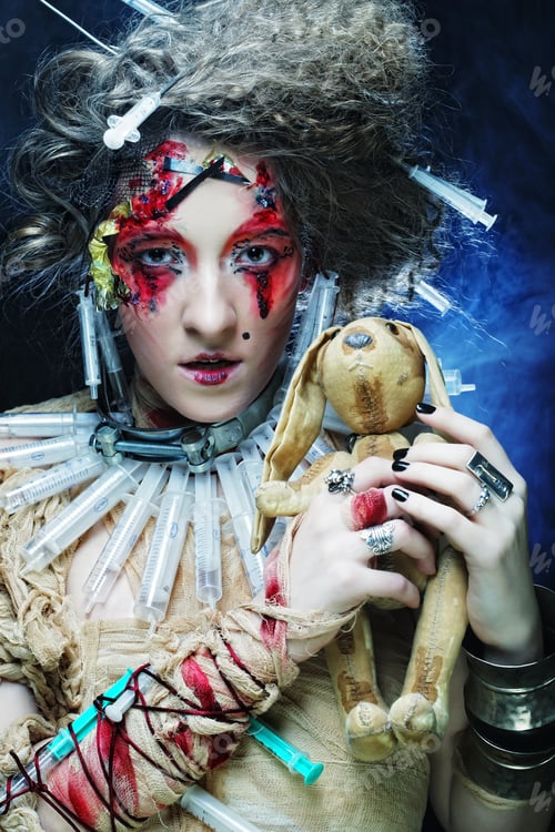 Preview: Young Woman With Creative Make Up Holding Little Rabbit. Halloween Theme.