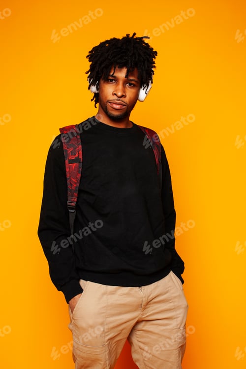 Preview: Young Handsome African American Guy Student Posing Cheerful And Gesturing On Yellow Background
