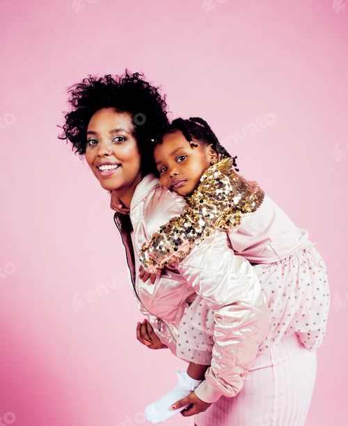 Preview: Young Pretty African-American Mother With Little Cute Daughter Hugging, Happy Smiling On Pink