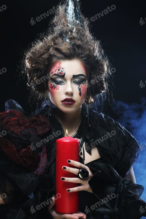 Preview: Young Woman With Creative Make Up Holding Candle. Halloween Theme.