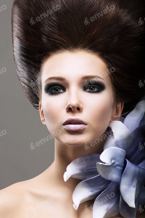 Preview: Elegance. Portrait Of Young Brunette With Flower. Classy Coiffure And Bright Makeup