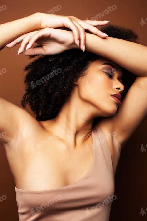 Preview: Pretty Young African American Woman With Curly Hair Posing Cheerful Gesturing On Brown Background
