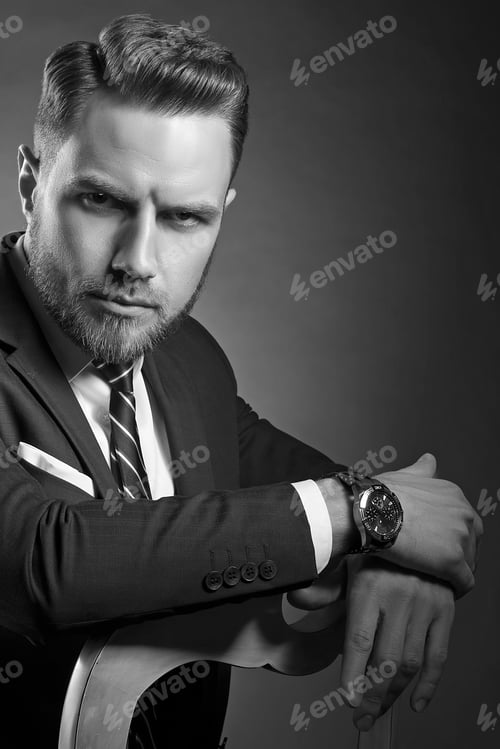 Preview: Young Handsome Bearded Caucasian Man With Blue Eyes Sitting On Chair. Perfect Skin And Hairstyle