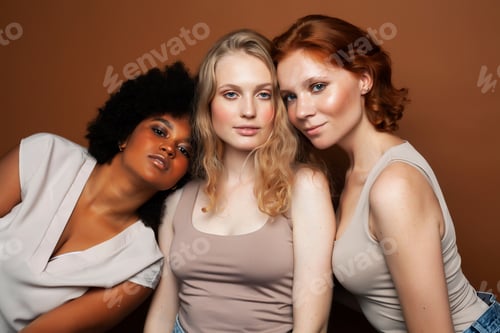 Preview: Young Pretty African And Caucasian Women Posing Cheerful Together On Brown Background, Lifestyle