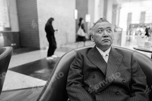 Preview: Mature Asian Businessman Relaxing Inside The Coffee Shop