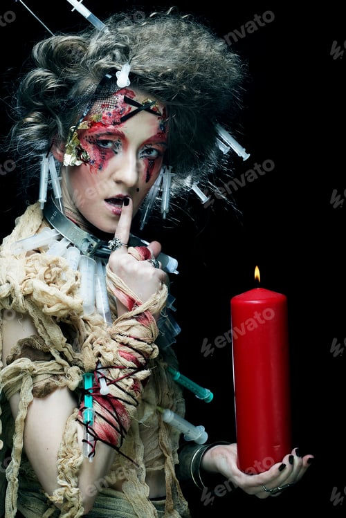 Preview: Young Woman With Bright Make Up Wearing Carnival Costume Holding A Candle. Halloween Picture.