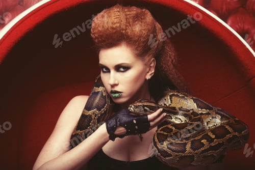Preview: Attractive Woman In Red Chair Holdung Python