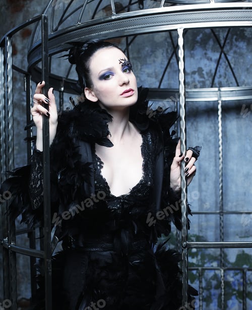 Vista previa: Fashion Model In Fantasy Dress Posing In Steel Cage.