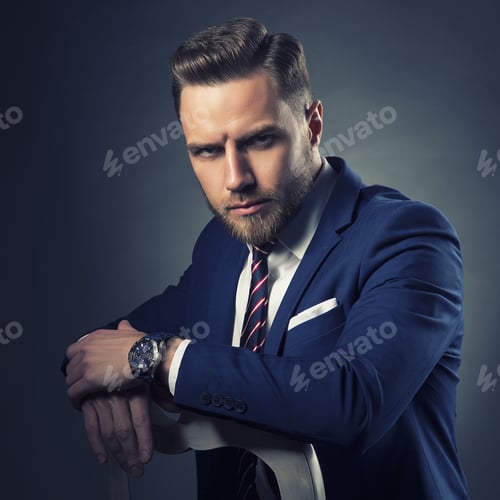 Preview: Young Handsome Bearded Caucasian Man With Blue Eyes Sitting On Chair. Perfect Skin And Hairstyle