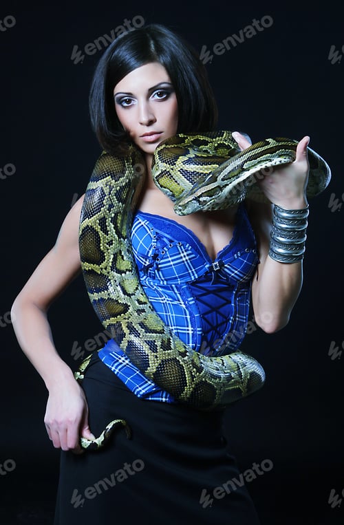 Preview: Sexy Brunette Holding Python Over Black Background