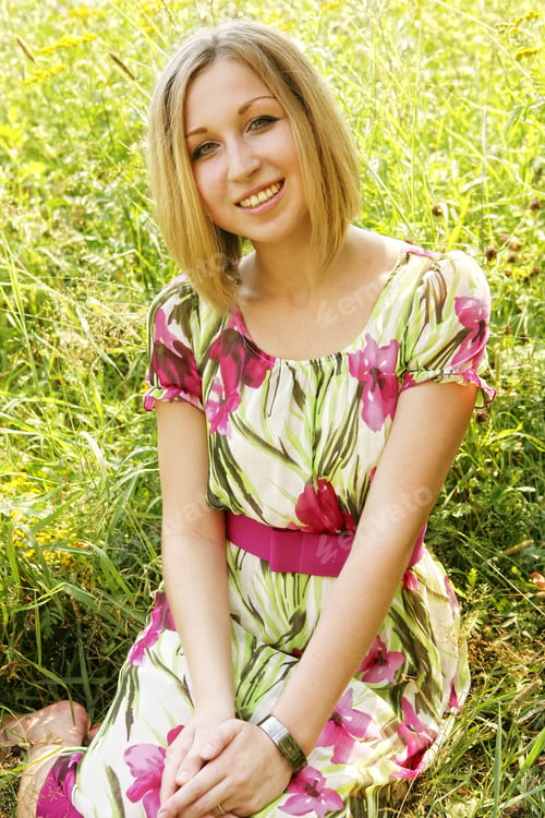 Preview: Beautiful Young Woman Relaxing In The Grass