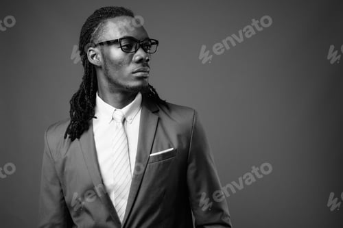 Preview: Young Handsome African Businessman Wearing Eyeglasses Against Brown Background