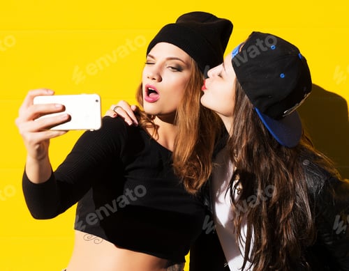 Preview: Two Teenage Girls Friends In Hipster Outfit Outdoors Make Selfie On A Phone.