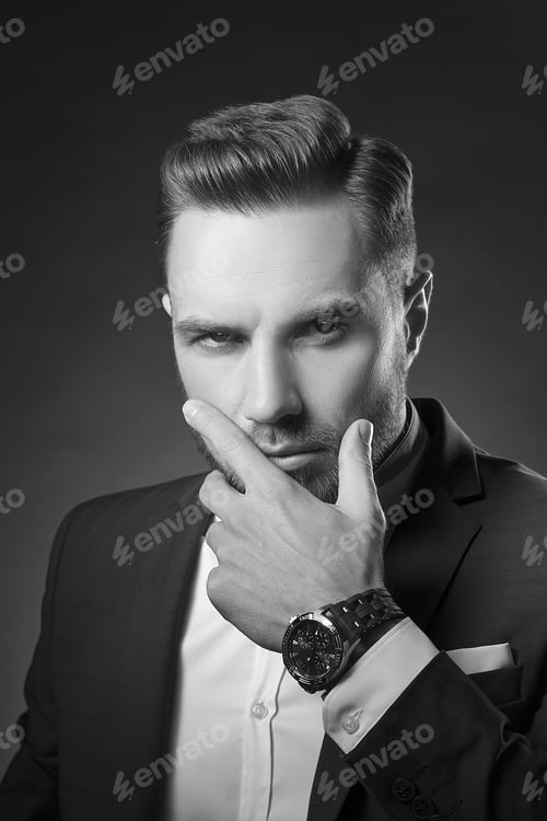 Preview: Young Handsome Bearded Caucasian Man With Blue Eyes. Perfect Skin And Hairstyle. Wearing Blue Suit